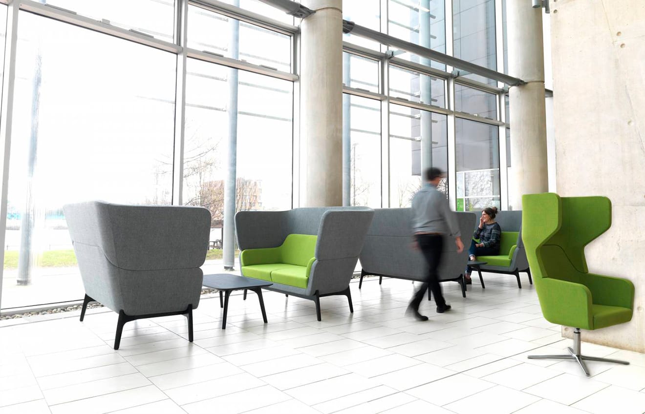 A group of people sitting on office sofas in a reception area