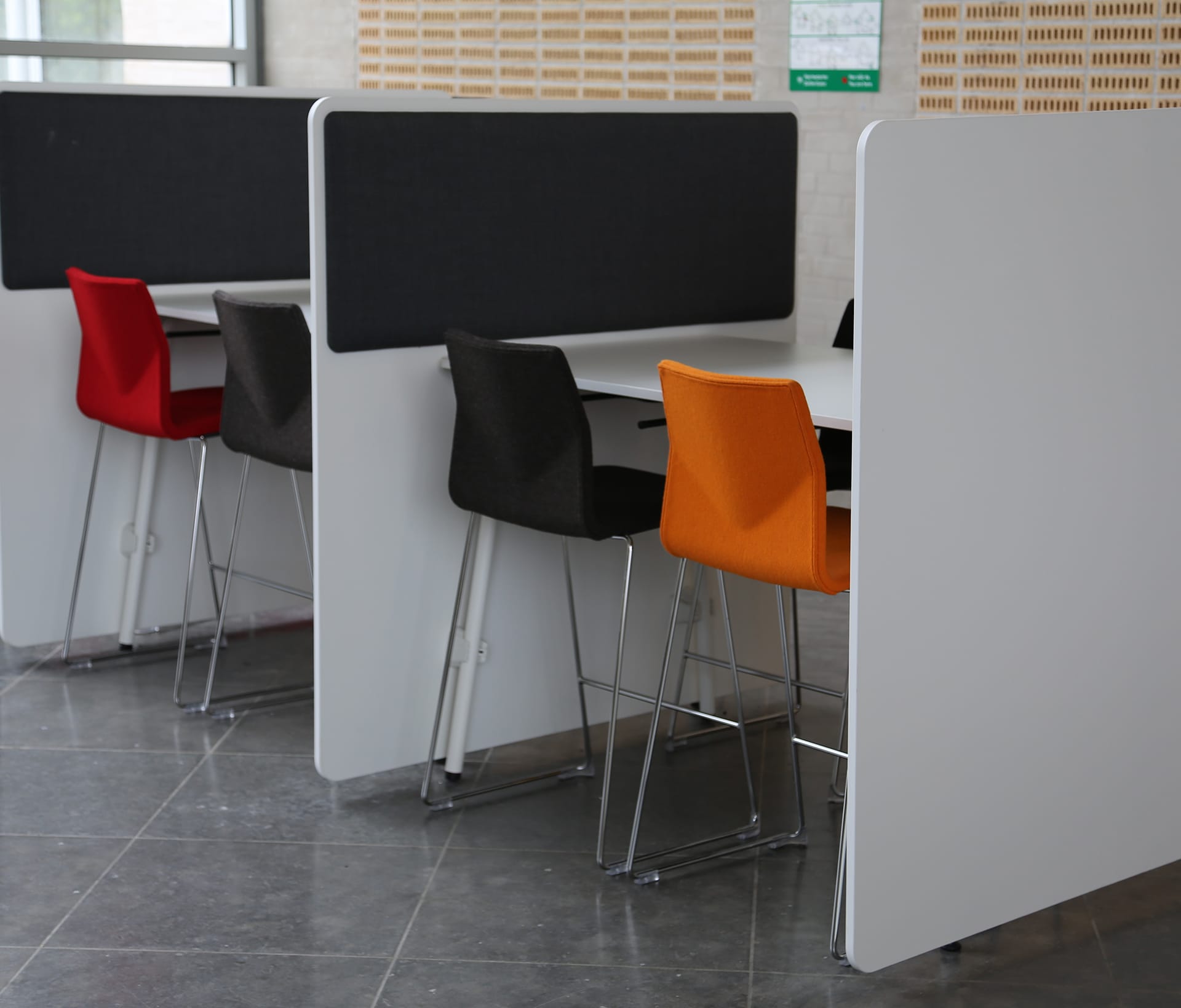 A group of chairs placed against some study booths