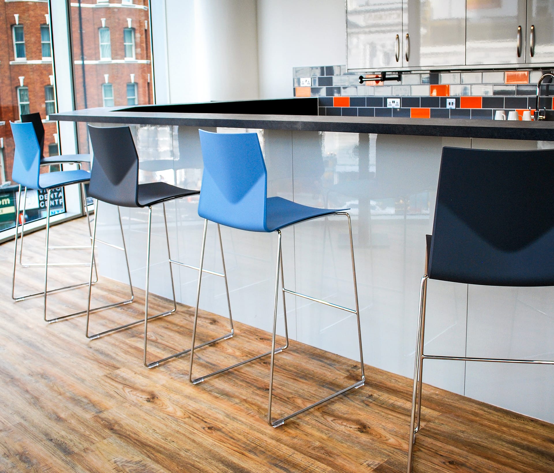 A row of counter chairs in a kitchen.