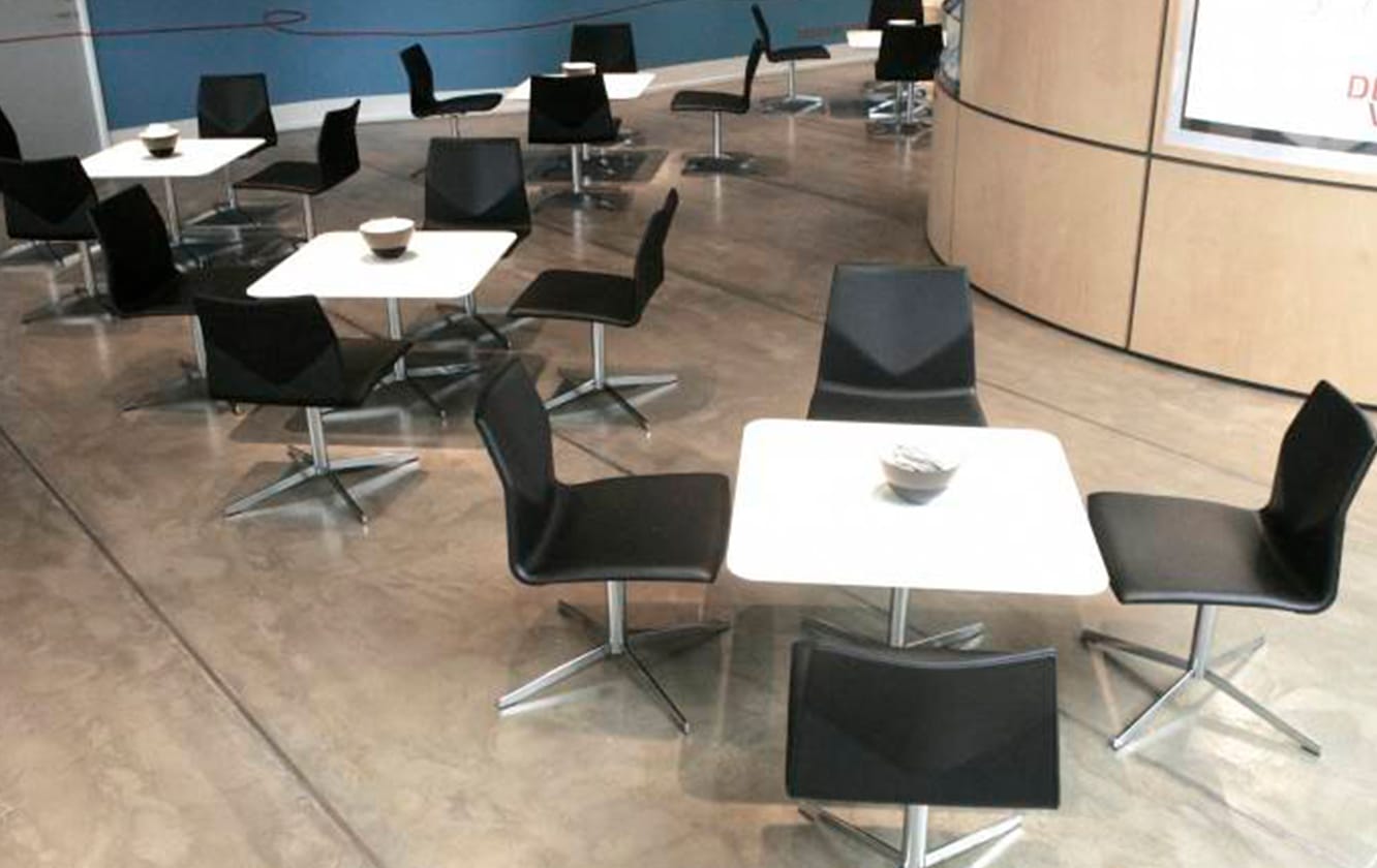 A group of black meeting table chairs and tables in a room.