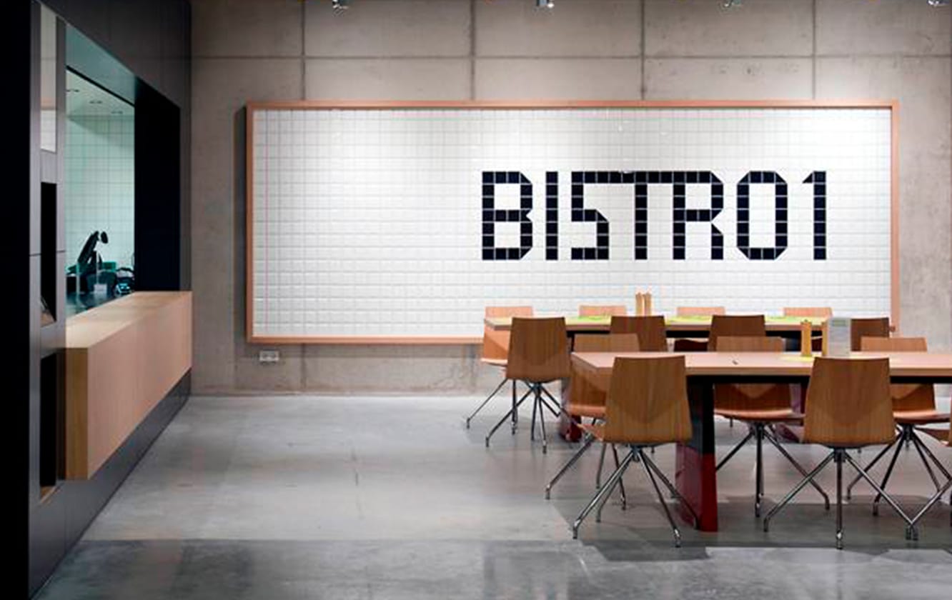 A restaurant with tables and chairs and a sign that says bistro 101.