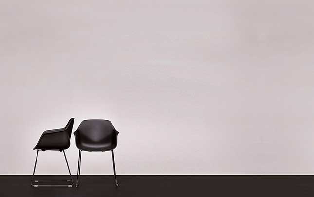 two office desk chairs against a white wall