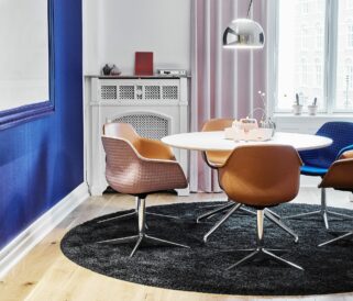 A round table and chairs in a room with blue walls.
