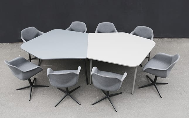 Four grey meeting table chairs and a table in a circle.