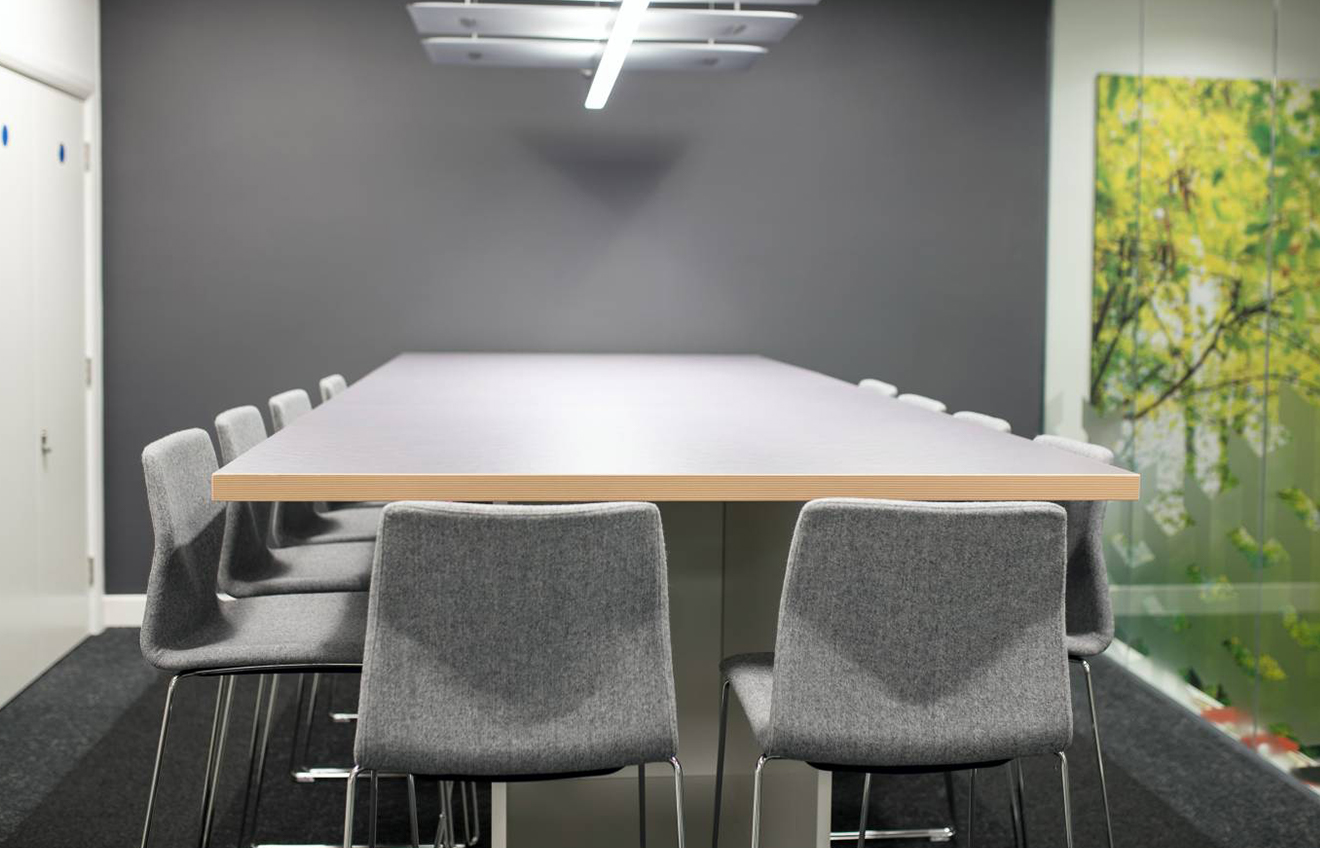 A conference room with a large table and meeting table chairs