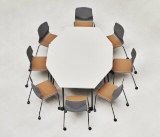 An octagonal table with six meeting table chairs around it.