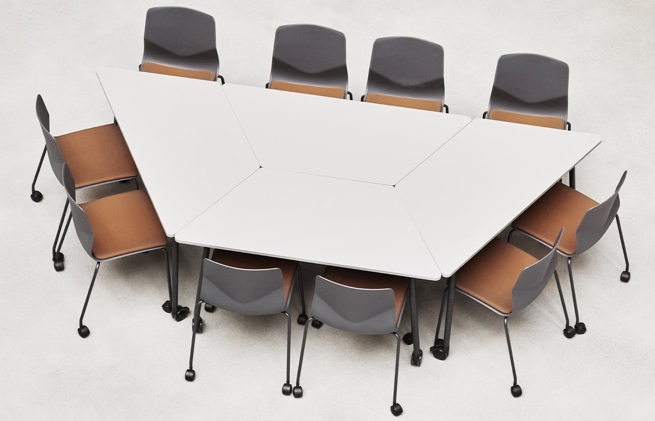 A conference table with meeting table chairs around it.