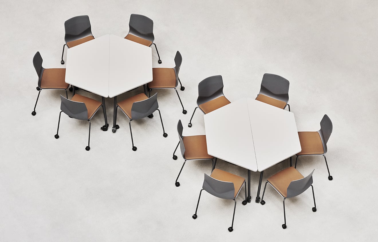 A group of meeting table chairs and tables in a room.