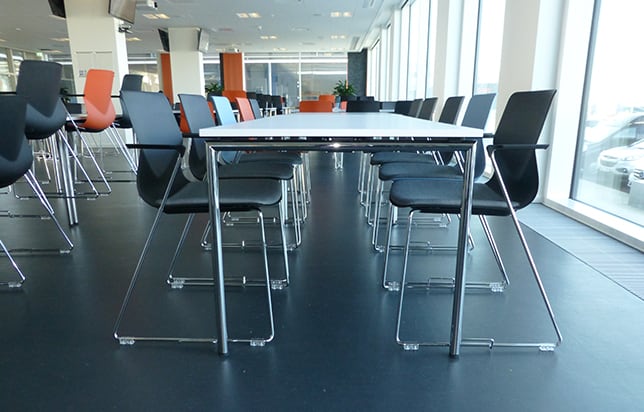 A conference table and meeting table chairs in a conference room.