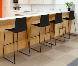 Four black counter chairs in a kitchen.