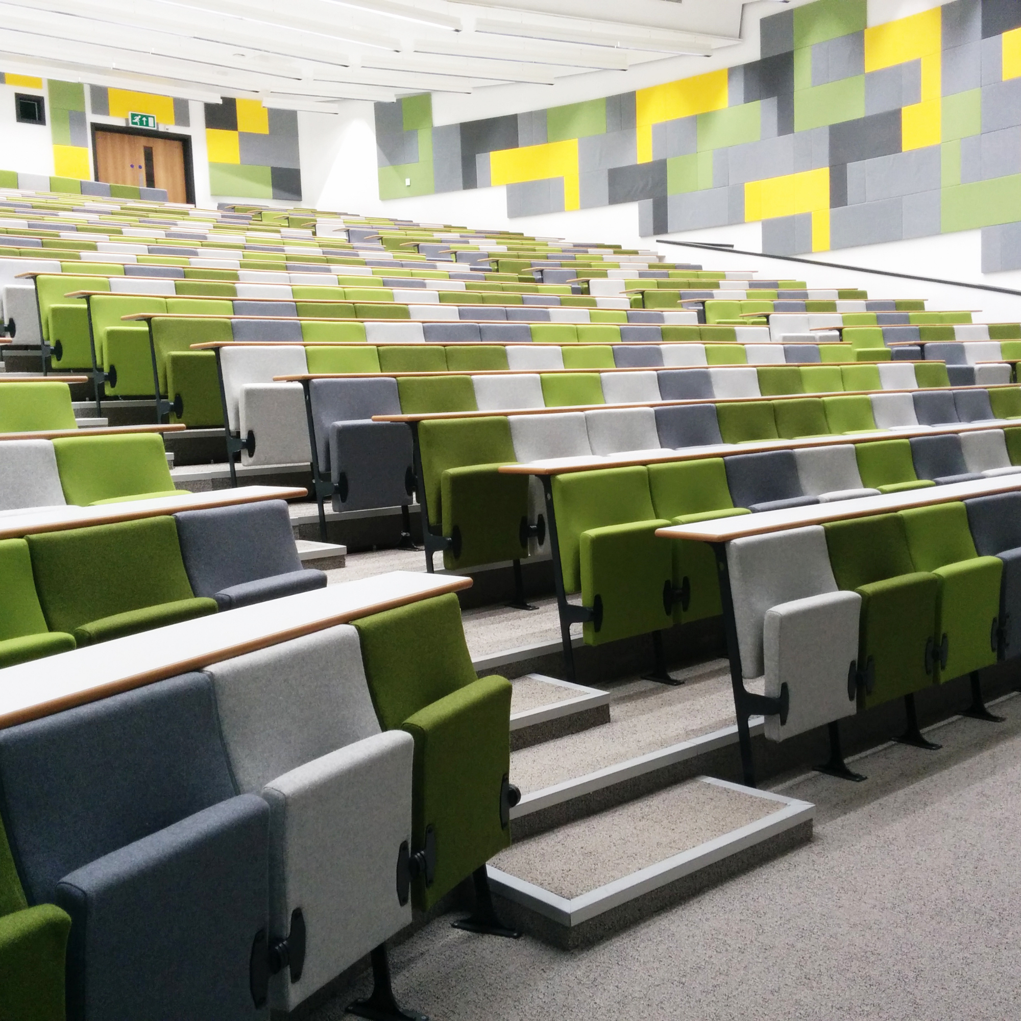 Grey and green auditorium seating in an auditorium.
