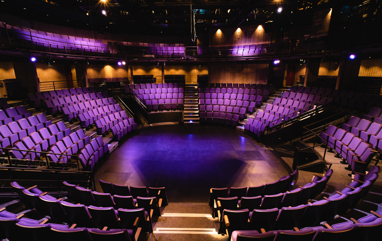 A row of purple auditorium seating in an auditorium.