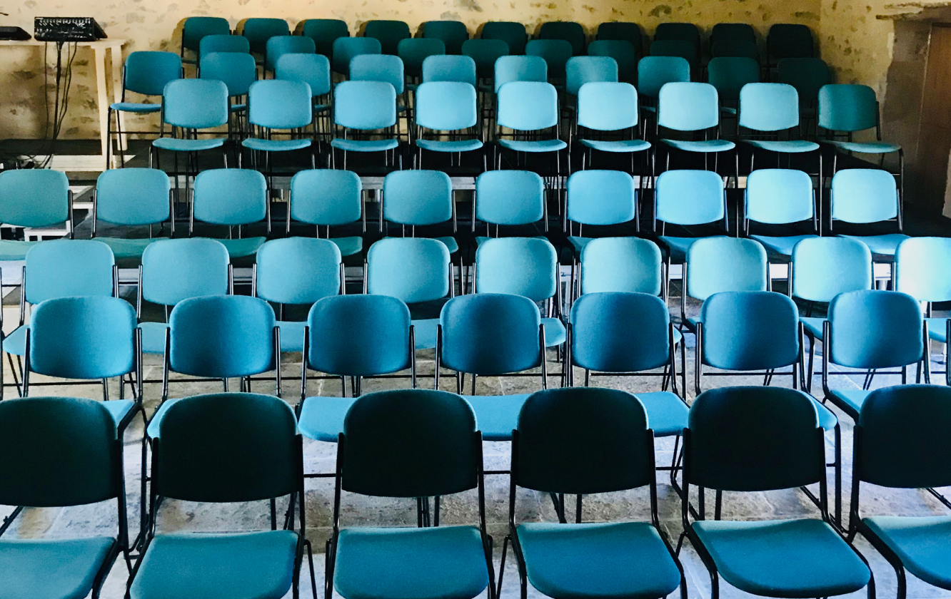 A row of blue chairs in a room.