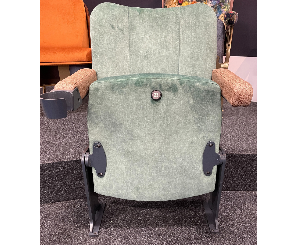 A green theatre chair with a metal frame.