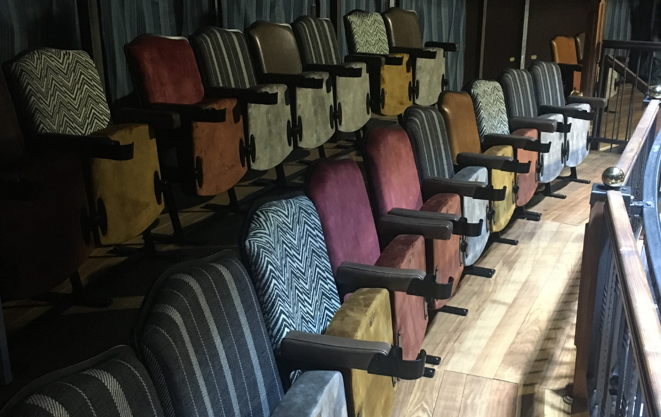 A row of bespoke seating in an auditorium.