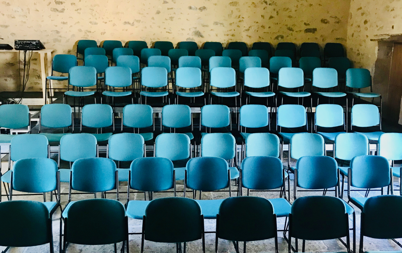 A row of blue chairs in a room.