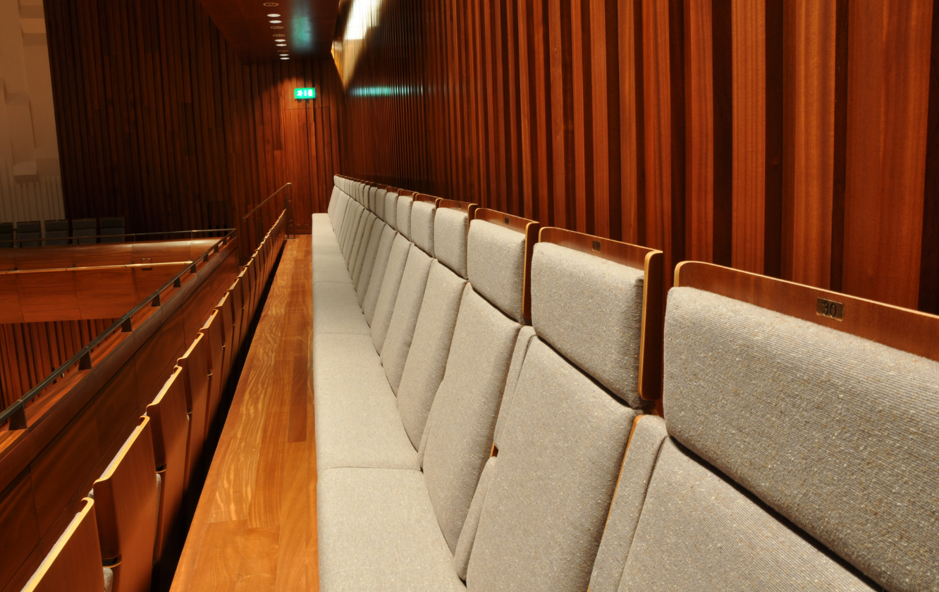 An auditorium with grey theater style seating