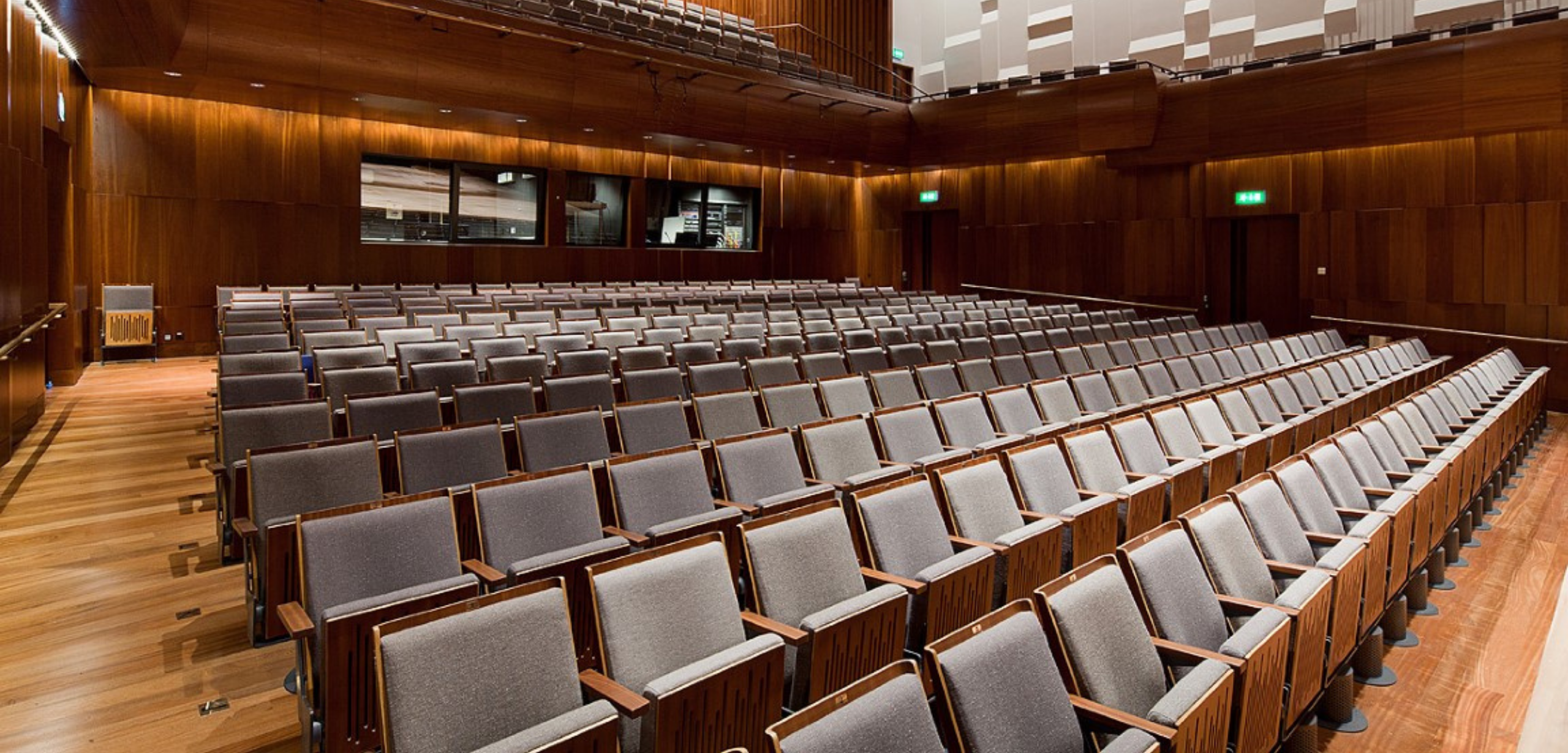 An auditorium with grey theater style seating