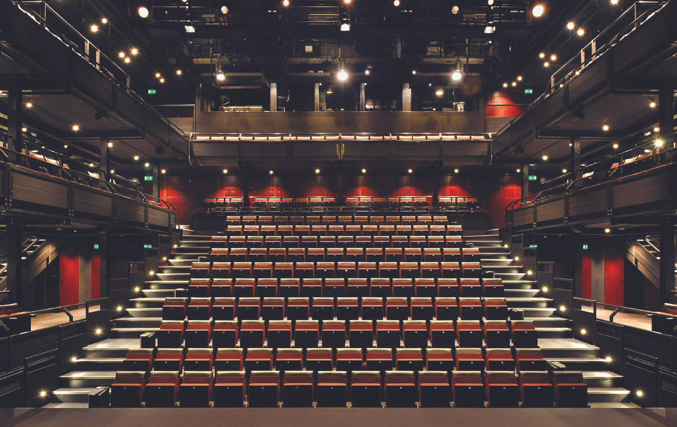 An empty auditorium with rows of auditorium seating