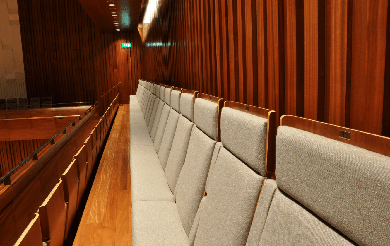 A row of tip up seating in a room.