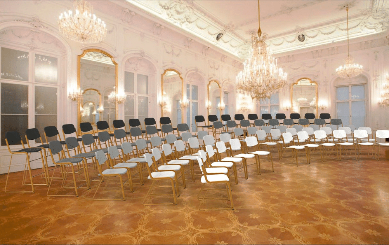 A large room with many chairs and a chandelier.