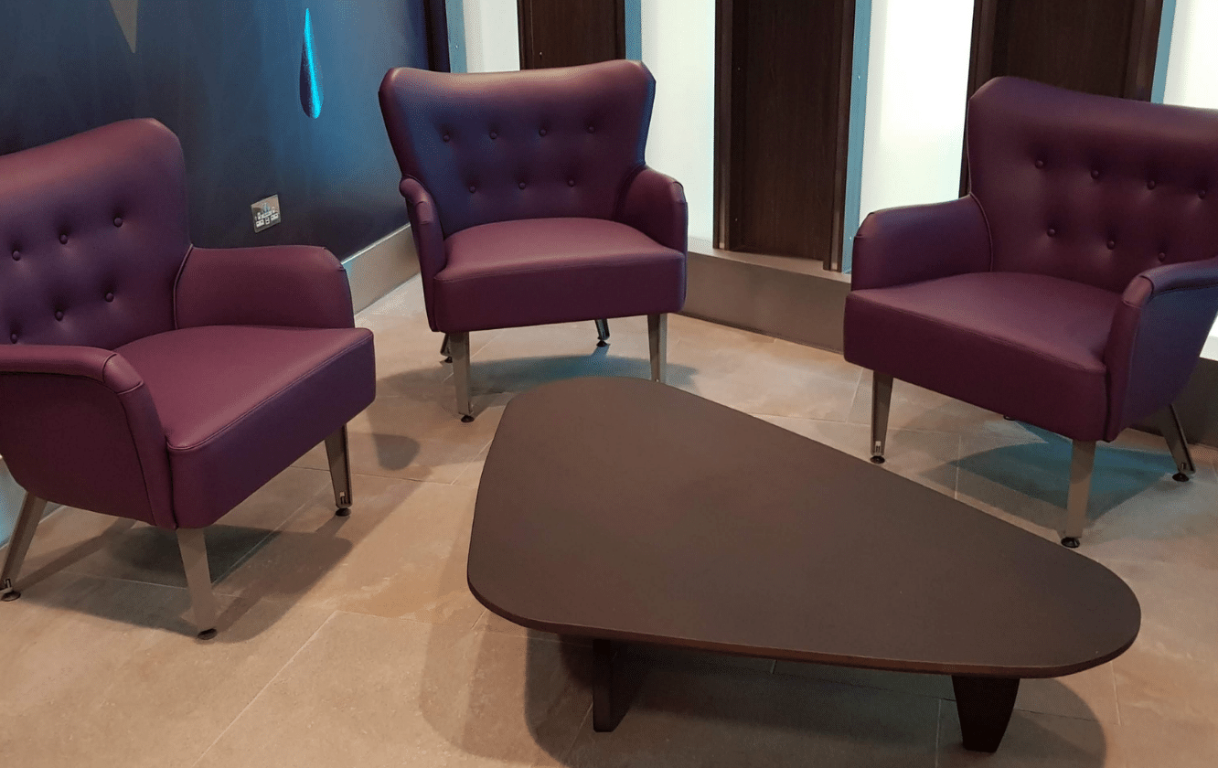 hospitality seating, including Three purple chairs and a coffee table