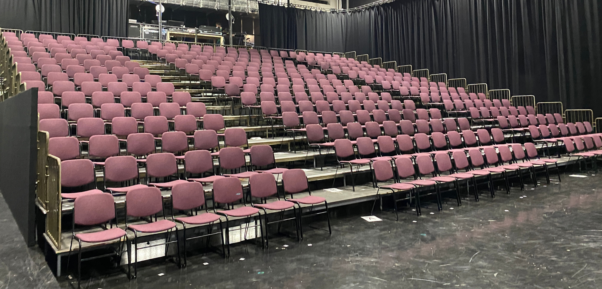 A large auditorium with rows of purple auditorium seating