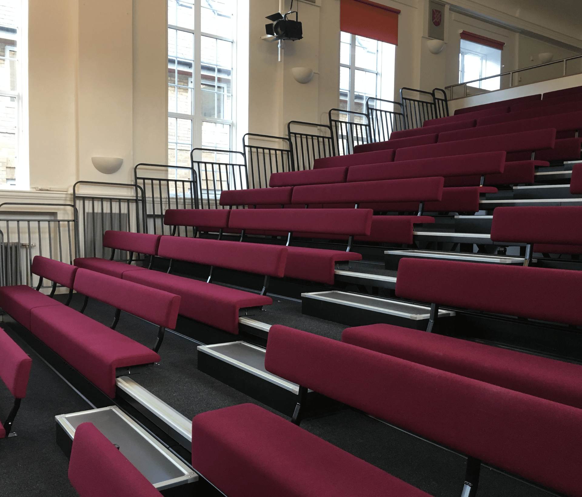 A row of bench seating in a large auditorium.
