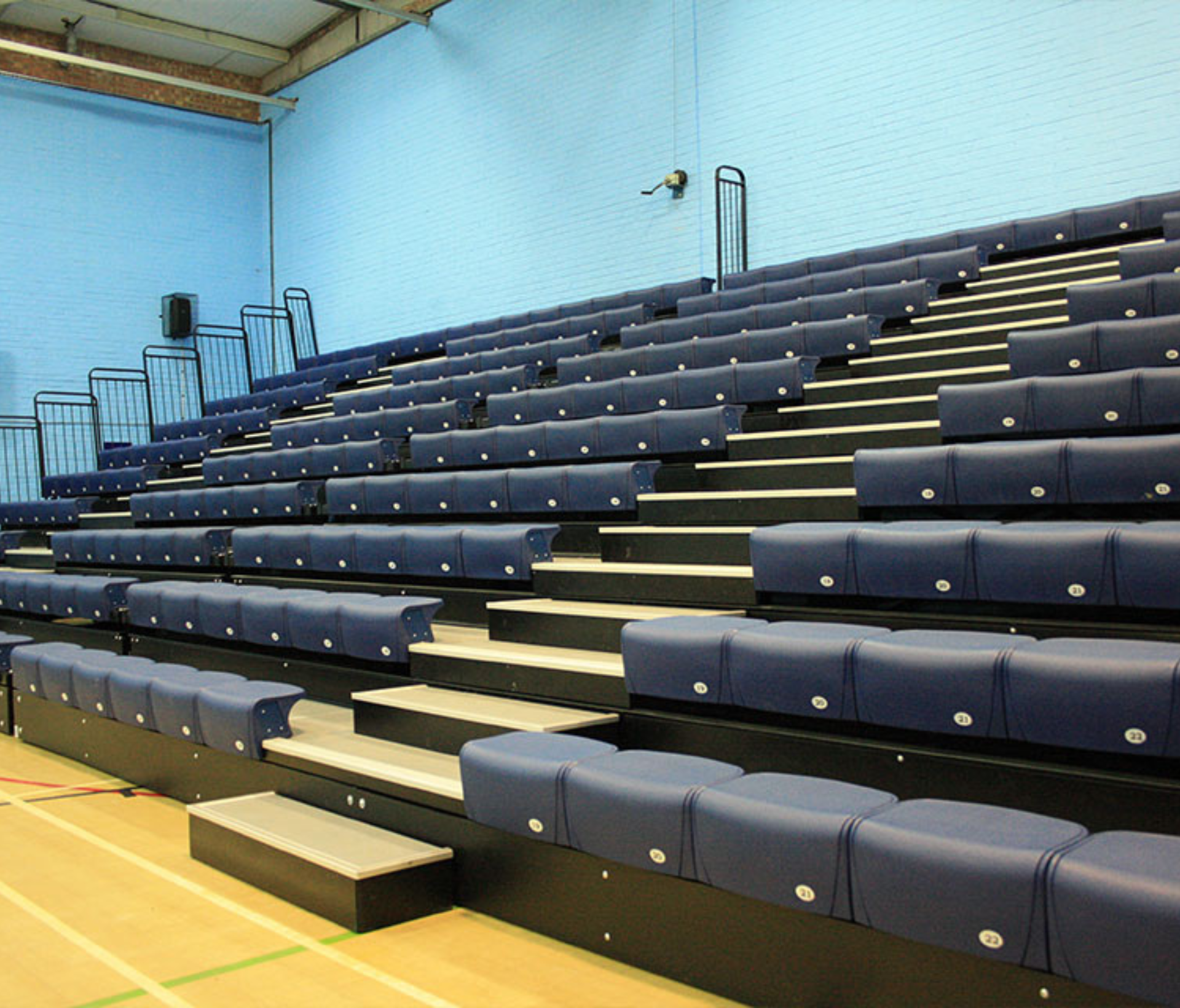 A row of blue seats in a stadium.