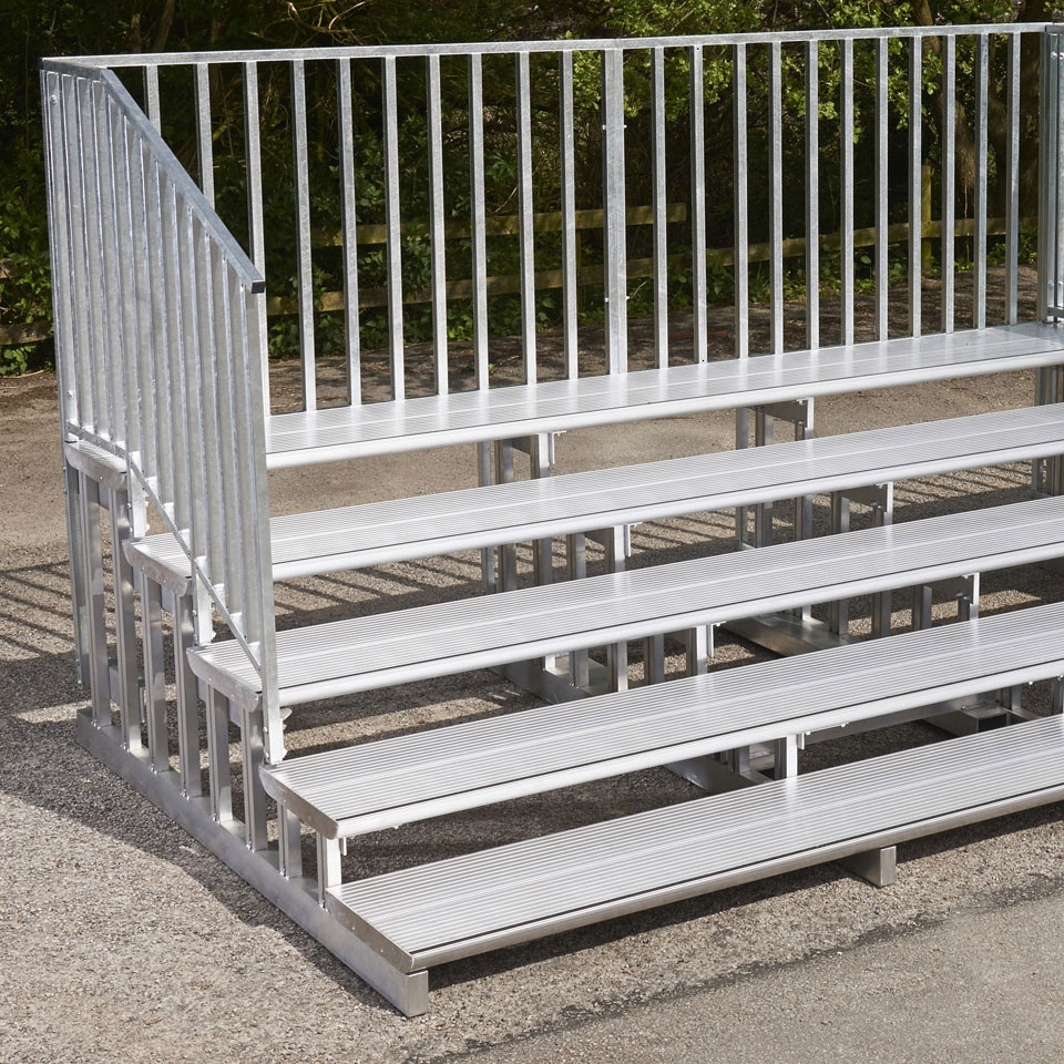 A set of bleachers with a metal railing.