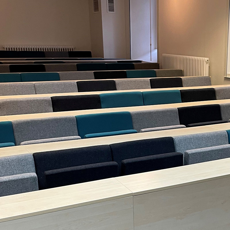 A lecture hall with rows of auditorium seating