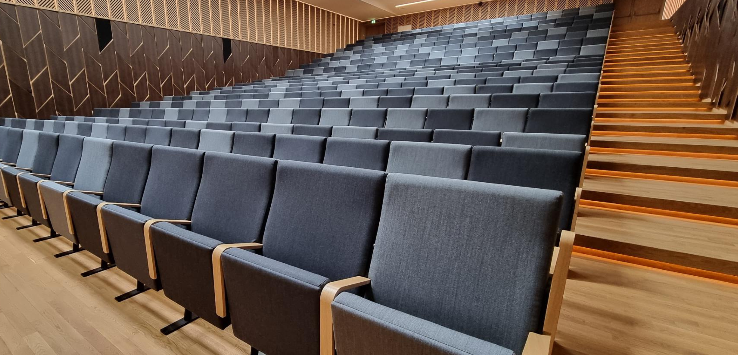 rows of grey seats in an auditorium